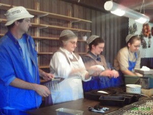 Matt and Loretta Burkey, Rachel Burkey Miller and Darla Orendorf Kremer shape and prick the loaves.
